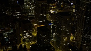 5K aerial stock footage reveal base of Rainier Tower in Downtown Seattle, Washington, night Aerial Stock Footage | AX51_086E