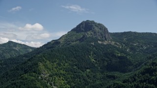 5K aerial stock footage of rocky peak covered by evergreen forest in the Cascade Range, Washington Aerial Stock Footage | AX52_039