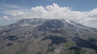 5K aerial stock footage approach cloud-capped Mount St. Helens with patches of snow, Washington Aerial Stock Footage | AX52_046