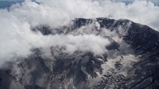 AX52_062E - 5K aerial stock footage approach the Mount St. Helens crater with low clouds, Washington