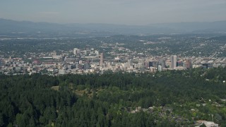 5K aerial stock footage fly over wooded hills toward city buildings, Downtown Portland, Oregon Aerial Stock Footage | AX53_012E