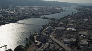 AX53_022E - 5K aerial stock footage of orbiting the Fremont Bridge revealing downtown buildings, Downtown Portland, Oregon