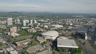 5K aerial stock footage tilt from Moda Center revealing downtown and Willamette River, Downtown Portland, Oregon Aerial Stock Footage | AX53_037E