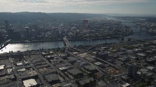 AX53_047 - 5K aerial stock footage of Downtown Portland cityscape seen from industrial area, Portland, Oregon