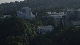 AX53_066E - 5K aerial stock footage of tracking a gondola through Oregon Health and Science University, Portland