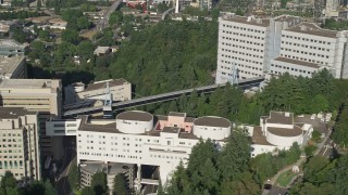 AX53_069E - 5K aerial stock footage fly by Oregon Health and Science University revealing Downtown Portland, Oregon