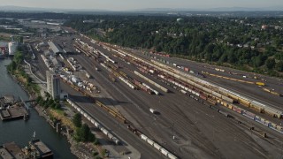 5K aerial stock footage of flying by trains at a train yard, North Portland, Oregon Aerial Stock Footage | AX53_080