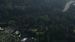 5K aerial stock footage fly by Children's Museum among trees revealing Highway 26, Southwest Portland, Oregon Aerial Stock Footage | AX53_088