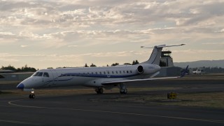 5K aerial stock footage of tracking a jet taxiing, ascending over Hillsboro Airport, Hillsboro, Oregon, sunset Aerial Stock Footage | AX54_001