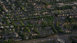 AX54_002 - 5K aerial stock footage of passing the Church of Jesus Christ of Latter Day Saints, Beaverton, Oregon, sunset