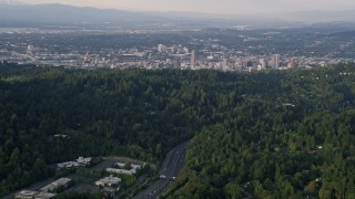 5K aerial stock footage of flying over Highway 26, tilt up to Downtown Portland, Oregon, sunset Aerial Stock Footage | AX54_014