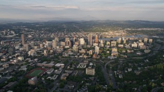 5K aerial stock footage of flying by downtown buildings beside the Willamette River, Downtown Portland, Oregon, sunset Aerial Stock Footage | AX54_019