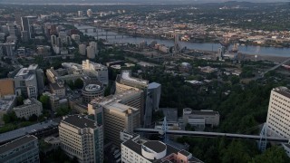 AX54_035 - 5K aerial stock footage orbit Oregon Health and Science University, reveal Downtown Portland, Oregon, sunset