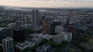 AX54_039 - 5K aerial stock footage of flying over downtown, approaching Fremont Bridge, Downtown Portland, Oregon, sunset