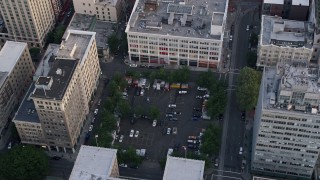 5K aerial stock footage of orbiting a parking lot and office buildings, Downtown Portland, Oregon, sunset Aerial Stock Footage | AX54_040