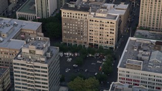 5K aerial stock footage of orbiting a parking lot by office buildings in Downtown Portland, Oregon, sunset Aerial Stock Footage | AX54_041