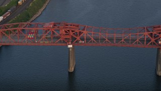 AX54_047 - 5K aerial stock footage of tracking a car crossing Broadway Bridge into Downtown Portland, Oregon, sunset