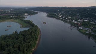 AX54_052 - 5K aerial stock footage of Willamette River by Ross Island, approach Toe Island, Portland, Oregon, sunset