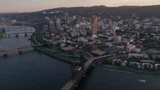 5K aerial stock footage fly by downtown, over Willamette River, Steel Bridge, Downtown Portland, Oregon, sunset Aerial Stock Footage | AX54_067