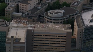 AX54_091E - 5K aerial stock footage of orbiting helicopter, Oregon Health and Science University, Portland, Oregon, twilight