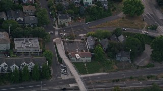 AX54_094 - 5K aerial stock footage of tracking gondola over I-5, Oregon Health and Science University, Portland, Oregon, twilight