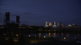 5K aerial stock footage twin spires on Oregon Convention Center lit up at twilight, Lloyd District, Northeast Portland, Oregon Aerial Stock Footage | AX55_001