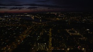 AX55_049E - 5K aerial stock footage approach the Fremont Bridge by following I-405 through Downtown Portland, Oregon, night