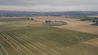 AX56_004E - 5K aerial stock footage approach a farmhouse beside a country road in Hillsboro, Oregon