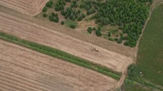 5K aerial stock footage of bird's eye view of a tractor plowing a field, Banks, Oregon Aerial Stock Footage | AX56_012