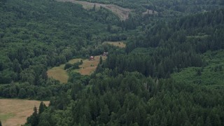 5K aerial stock footage of isolated farmhouse and barn in Clatsop County, Oregon Aerial Stock Footage | AX56_039