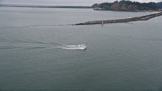 5K aerial stock footage approach and track a fishing boat sailing on the Columbia River near Cape Disappointment, Washington Aerial Stock Footage | AX56_087