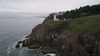 AX56_118E - 5K aerial stock footage approach the North Head Light on a steep cliff in Ilwaco, Washington