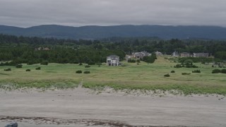 5K aerial stock footage of homes and green fields near the beach in Long Beach, Washington Aerial Stock Footage | AX56_133