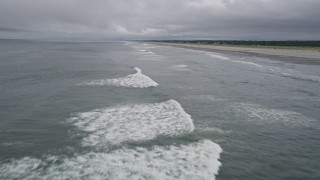 5K aerial stock footage fly low over ocean waves and an empty beach in Long Beach, Washington Aerial Stock Footage | AX56_138E