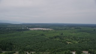 5K aerial stock footage approach the Washington Corrections Center, surrounded by evergreen forest in Shelton, Washington Aerial Stock Footage | AX57_034