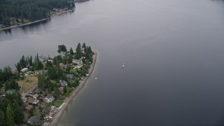 5K aerial stock footage of sailboat on Case Inlet beside Reach Island waterfront homes, Grapeview, Washington Aerial Stock Footage | AX58_023