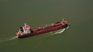 AX59_010 - 5K aerial stock footage of an oil tanker sailing on Mississippi River, New Orleans, Louisiana