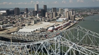 5K aerial stock footage flying over the Crescent City Connection, with view of convention center and Downtown New Orleans, Louisiana Aerial Stock Footage | AX59_011E