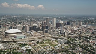 AX59_029 - 5K aerial stock footage of Downtown New Orleans skyscrapers and Mercedes-Benz Superdome, Louisiana