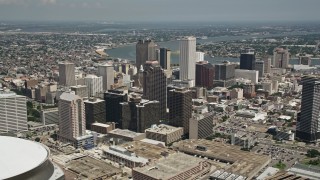 5K aerial stock footage fly over Superdome and New Orleans arena to approach skyscrapers in Downtown New Orleans, Louisiana Aerial Stock Footage | AX59_030E