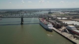 5K aerial stock footage of cruise ship docked beside the Crescent City Connection Bridge, New Orleans, Louisiana Aerial Stock Footage | AX59_043