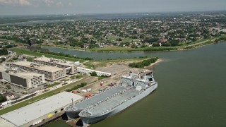 AX59_047 - 5K aerial stock footage fly over two military transports to approach homes in the Lower Ninth Ward, New Orleans, Louisiana