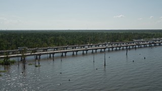 AX60_004E - 5K aerial stock footage of light traffic on Interstate 10 beside swamp in Norco, Louisiana