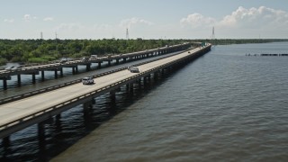 AX60_007E - 5K aerial stock footage of following light traffic on Interstate 10, Norco, Louisiana