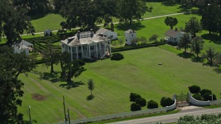 AX60_027E - 5K aerial stock footage orbit the Evergreen Plantation main and side buildings in Edgard, Louisiana