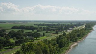 AX60_032E - 5K aerial stock footage of rural homes and State Route 18 in Vacherie, Louisiana