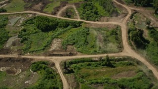 AX60_037 - 5K aerial stock footage of a bird's eye view of dirt roads by a pond in Vacherie, Louisiana