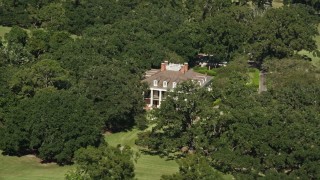 5K aerial stock footage orbit the Oak Valley Plantation, partially hidden by trees in Vacherie, Louisiana Aerial Stock Footage | AX60_043