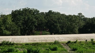 5K aerial stock footage fly over Mississippi River bank and trees to reveal roof of Oak Valley Plantation, Vacherie, Louisiana Aerial Stock Footage | AX60_047