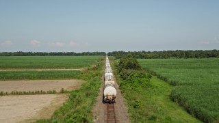 5K aerial stock footage approach the end of a train and fly over several rail cars in Vacherie, Louisiana Aerial Stock Footage | AX60_062